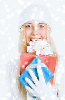 Happy woman holding Christmas gifts, silver background and snow glitter with copyspace, shopping and holidays