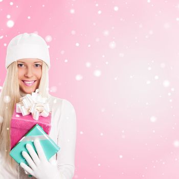 Happy woman holding Christmas gifts, pink background and snow glitter with copyspace, shopping and holidays