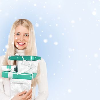 Happy woman holding Christmas gifts, blue background and snow glitter with copyspace, shopping and holidays