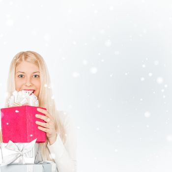 Happy woman holding Christmas gifts, silver background and snow glitter with copyspace, shopping and holidays