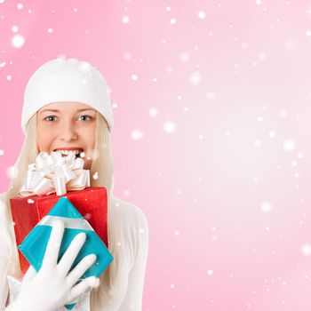 Happy woman holding Christmas gifts, pink background and snow glitter with copyspace, shopping and holidays