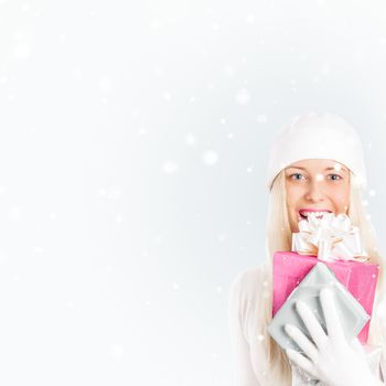 Happy woman holding Christmas gifts, silver background and snow glitter with copyspace, shopping and holidays