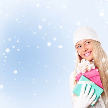 Happy woman holding Christmas gifts, blue background and snow glitter with copyspace, shopping and holidays