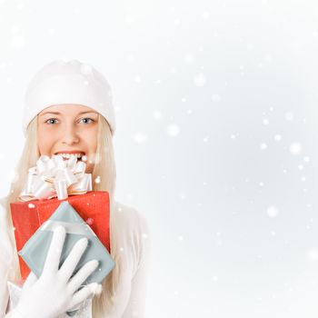 Happy woman holding Christmas gifts, silver background and snow glitter with copyspace, shopping and holidays