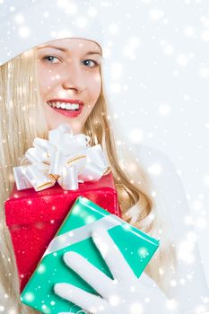 Happy woman holding Christmas gifts, silver background and snow glitter with copyspace, shopping and holidays