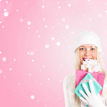 Happy woman holding Christmas gifts, pink background and snow glitter with copyspace, shopping and holidays