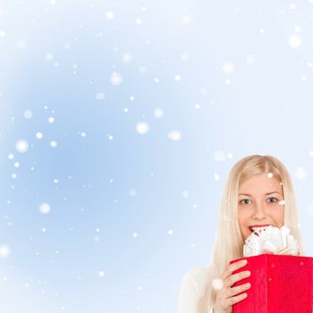 Happy woman holding Christmas gifts, blue background and snow glitter with copyspace, shopping and holidays