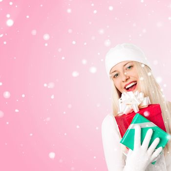 Happy woman holding Christmas gifts, pink background and snow glitter with copyspace, shopping and holidays