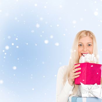 Happy woman holding Christmas gifts, blue background and snow glitter with copyspace, shopping and holidays