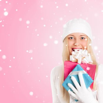 Happy woman holding Christmas gifts, pink background and snow glitter with copyspace, shopping and holidays