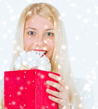 Happy woman holding Christmas gifts, silver background and snow glitter with copyspace, shopping and holidays