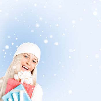 Happy woman holding Christmas gifts, blue background and snow glitter with copyspace, shopping and holidays