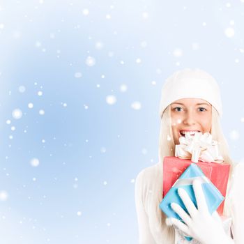 Happy woman holding Christmas gifts, blue background and snow glitter with copyspace, shopping and holidays