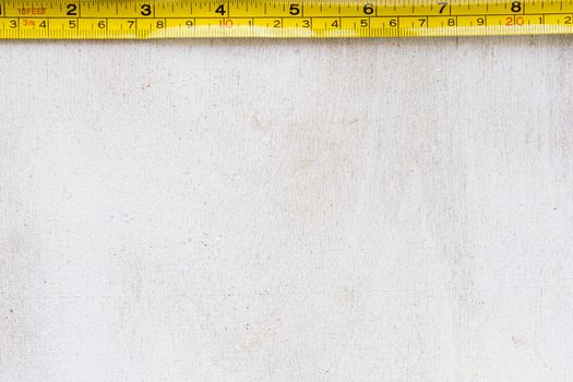 Tape measure centimeters and millimeters on the yellow ruler. Sizes on the white background