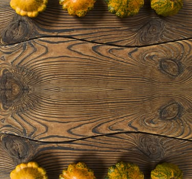 Variety of pumpkins on a wood background. Harvest concept flat lay with copy space.