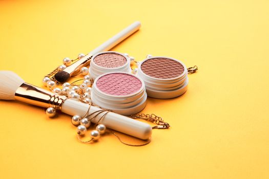 Eyeshadow eye makeup brush on yellow background top view Copy Space. High quality photo