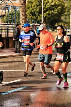 Santa Pola, Spain- January 20, 2019: Runners in the Half Marathon of the fishing village of Santa Pola, province of Alicante, on a sunny day in January