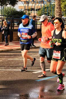 Santa Pola, Spain- January 20, 2019: Runners in the Half Marathon of the fishing village of Santa Pola, province of Alicante, on a sunny day in January