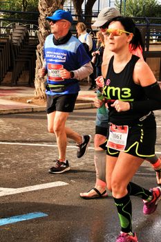 Santa Pola, Spain- January 20, 2019: Runners in the Half Marathon of the fishing village of Santa Pola, province of Alicante, on a sunny day in January