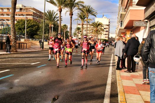Santa Pola, Spain- January 20, 2019: Runners in the Half Marathon of the fishing village of Santa Pola, province of Alicante, on a sunny day in January