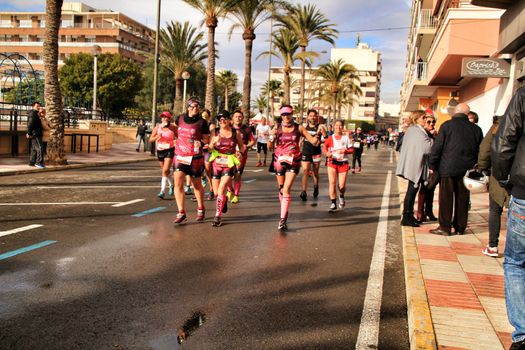 Santa Pola, Spain- January 20, 2019: Runners in the Half Marathon of the fishing village of Santa Pola, province of Alicante, on a sunny day in January