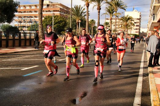 Santa Pola, Spain- January 20, 2019: Runners in the Half Marathon of the fishing village of Santa Pola, province of Alicante, on a sunny day in January