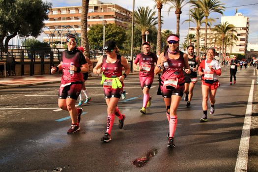 Santa Pola, Spain- January 20, 2019: Runners in the Half Marathon of the fishing village of Santa Pola, province of Alicante, on a sunny day in January