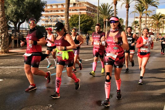 Santa Pola, Spain- January 20, 2019: Runners in the Half Marathon of the fishing village of Santa Pola, province of Alicante, on a sunny day in January
