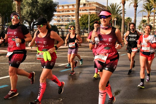 Santa Pola, Spain- January 20, 2019: Runners in the Half Marathon of the fishing village of Santa Pola, province of Alicante, on a sunny day in January