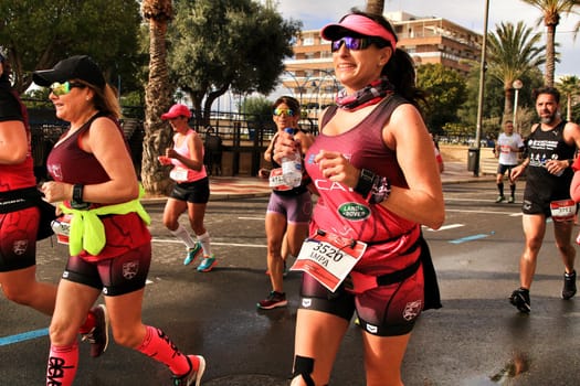 Santa Pola, Spain- January 20, 2019: Runners in the Half Marathon of the fishing village of Santa Pola, province of Alicante, on a sunny day in January