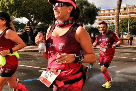 Santa Pola, Spain- January 20, 2019: Runners in the Half Marathon of the fishing village of Santa Pola, province of Alicante, on a sunny day in January