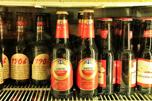 Alicante, Spain- January 16, 2019: Fridge with variety of international beers in a bar