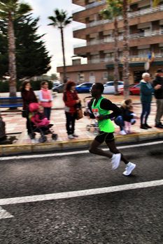 Santa Pola, Spain- January 20, 2019: Runners in the Half Marathon of the fishing village of Santa Pola, province of Alicante, on a sunny day in January