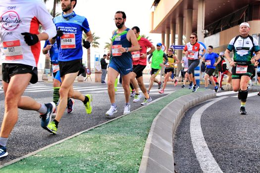 Santa Pola, Spain- January 20, 2019: Runners in the Half Marathon of the fishing village of Santa Pola, province of Alicante, on a sunny day in January