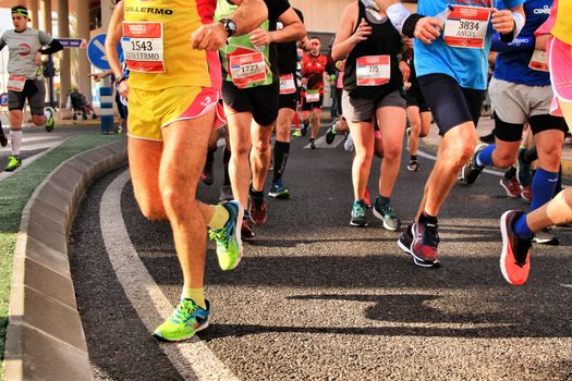 Santa Pola, Spain- January 20, 2019: Runners in the Half Marathon of the fishing village of Santa Pola, province of Alicante, on a sunny day in January