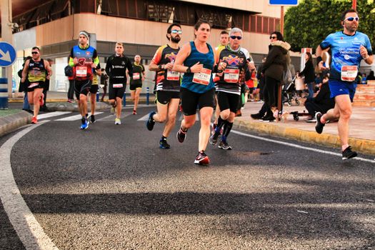 Santa Pola, Spain- January 20, 2019: Runners in the Half Marathon of the fishing village of Santa Pola, province of Alicante, on a sunny day in January
