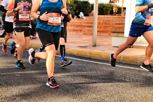 Santa Pola, Spain- January 20, 2019: Runners in the Half Marathon of the fishing village of Santa Pola, province of Alicante, on a sunny day in January