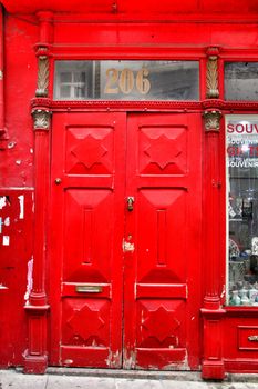Oporto, Portugal- January 2, 2020: Old and colorful red wooden door with iron details in Porto, Portugal