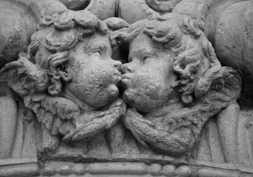 Elche, Alicante, Spain- July 20,2020: Beautiful Carved stone angels kissing on the main facade of Santa Maria church in Elche, Alicante, Spain.