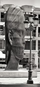 Elche, Alicante, Spain- July 20, 2020: Beautiful three-dimensional sculpture of a woman's face of the artist Jaume Plensa exhibited in the main square of Elche