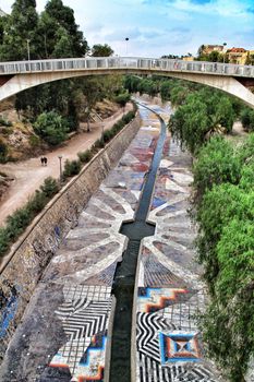 Elche, Alicante, Spain- September 12, 2018: Beautiful and Lush landscape of the Vinalopo riverbed in Elche, Alicante. People walking between vegetation.