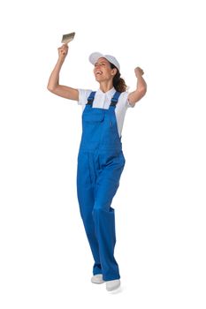 Female house painter with paint brush with raised arms isolated on white background full length studio portrait