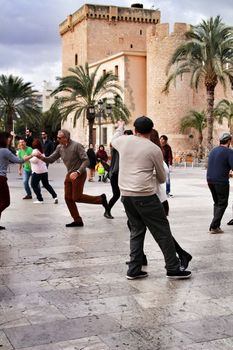 Elche, Alicante, Spain- February 19, 2019: People enjoying and dancing swing in the street in winter