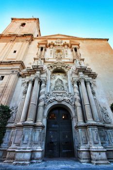 Elche, Alicante, Spain- September 9, 2020: Main entrance and beautiful Valencian baroque facade of Santa Maria church dedicated to the Lady of the Assumption