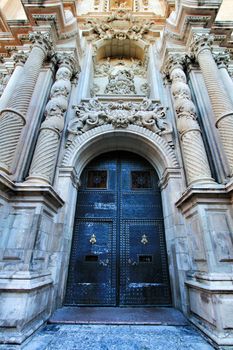 Elche, Alicante, Spain- September 9, 2020: Main entrance and beautiful Valencian baroque facade of Santa Maria church dedicated to the Lady of the Assumption