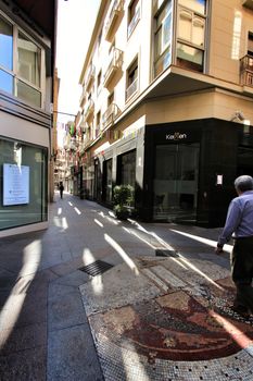 Elche, Alicante, Spain- October 7, 2020: People walking through Pedestrian street plenty of shops called El Salvador in the center of the city of Elche, Alicante province, Spain.