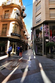 Elche, Alicante, Spain- October 7, 2020: People walking through Pedestrian street plenty of shops called El Salvador in the center of the city of Elche, Alicante province, Spain.