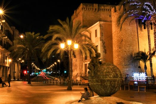 Elche, Alicante, Spain- December 11, 2019: People enjoying and walking at night through the beautiful streets of Elche decorated with lighting and Christmas motifs