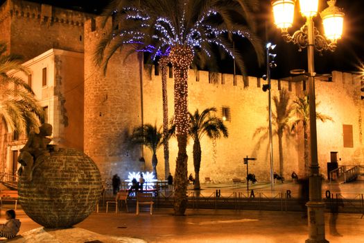 Elche, Alicante, Spain- December 11, 2019: People enjoying and walking at night through the beautiful streets of Elche decorated with lighting and Christmas motifs