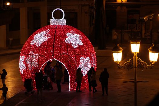 Elche, Alicante, Spain- December 11, 2019: People enjoying and walking at night through the beautiful streets of Elche decorated with lighting and Christmas motifs